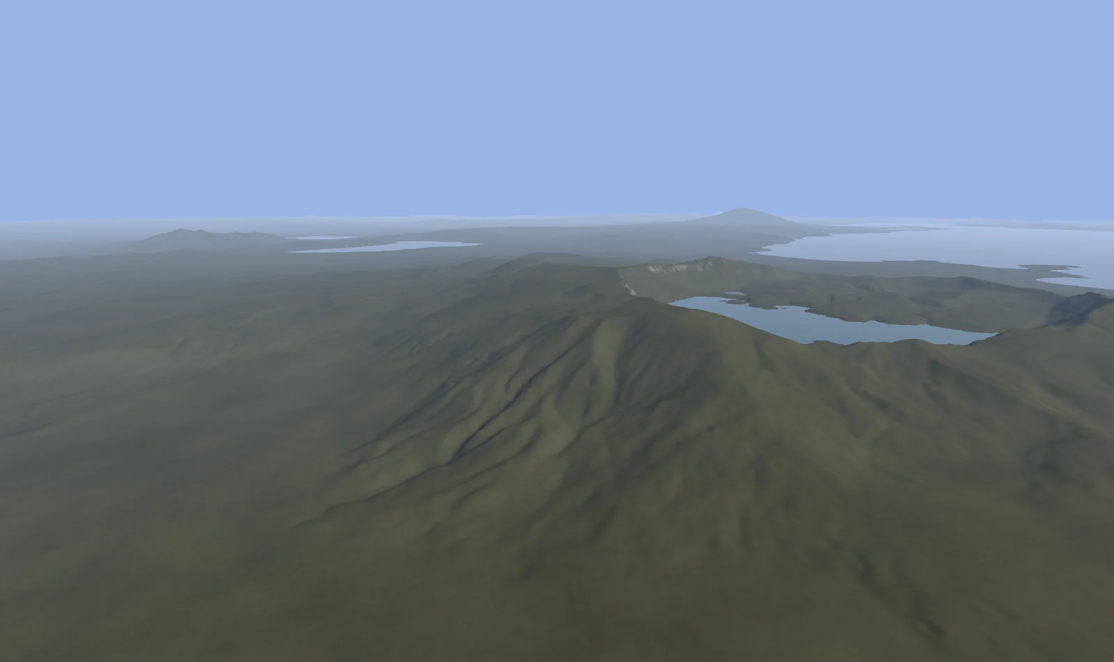A volcanic crater holding a lake, with the wide expanse of Lake Van and a distant volcano beyond.