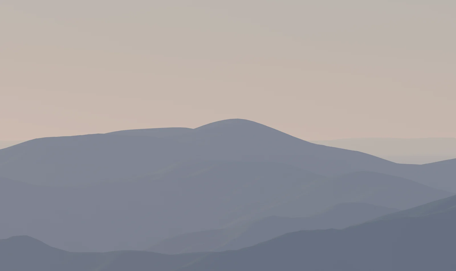 Blue mountain ridges layered one behind another, each paler than the last, under a soft afternoon sky.